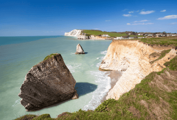 A cliffside overlooking the ocean in the Isle of Wight where a campsite is located for campervan family trips.