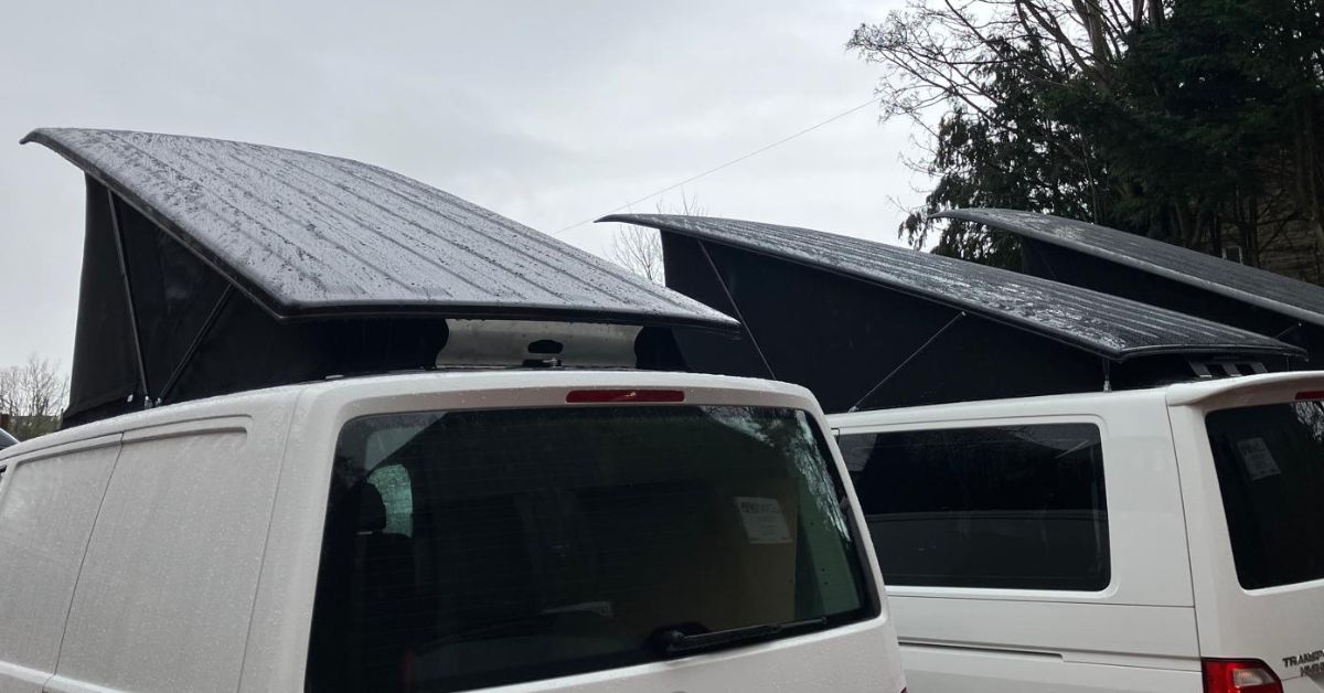 Rear view of VW T5–6.1 Transporter pop top roofs highlighting the hinge and strut differences between the Stealth B2 and B2B.