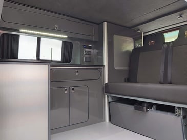 A Campervan with a custom design and interior after the owners wanted to make it their own with sleek, grey colour scheme.