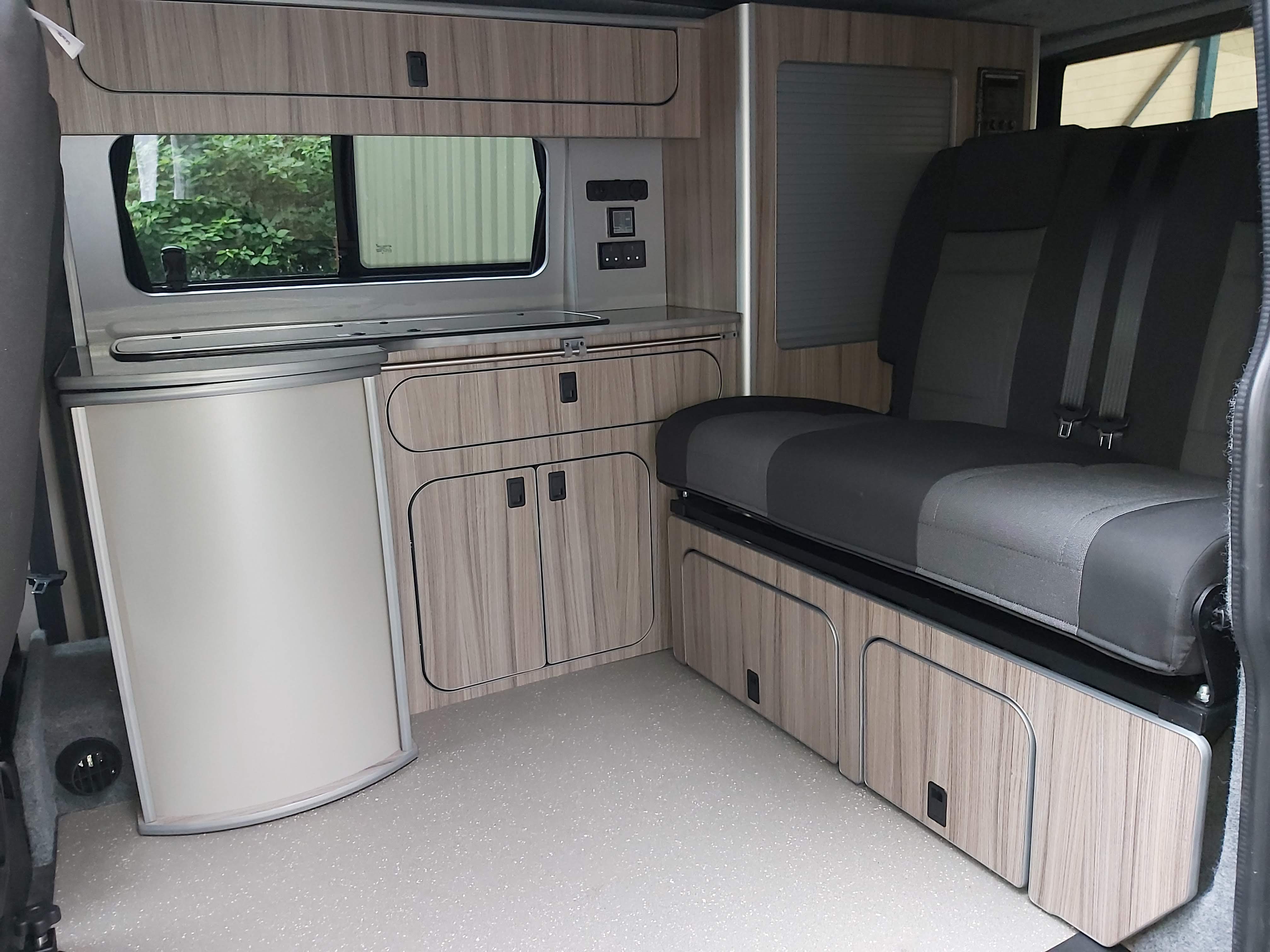 The inside of a campervan which has been converted to maximise space to fit more for less 